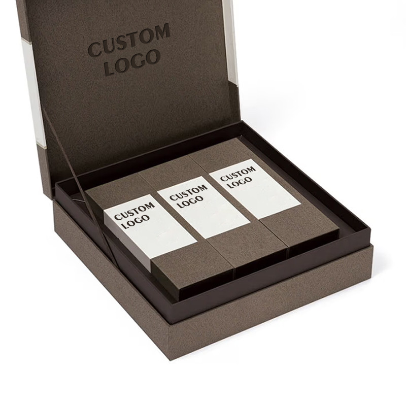 Brown hinged-lid custom tea gift packaging with three neat interior tea cartons and ribbon side support