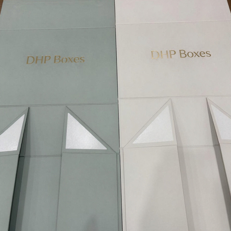 Two custom magnetic rigid gift box pre-production samples in soft green and off-white with matte surfaces
