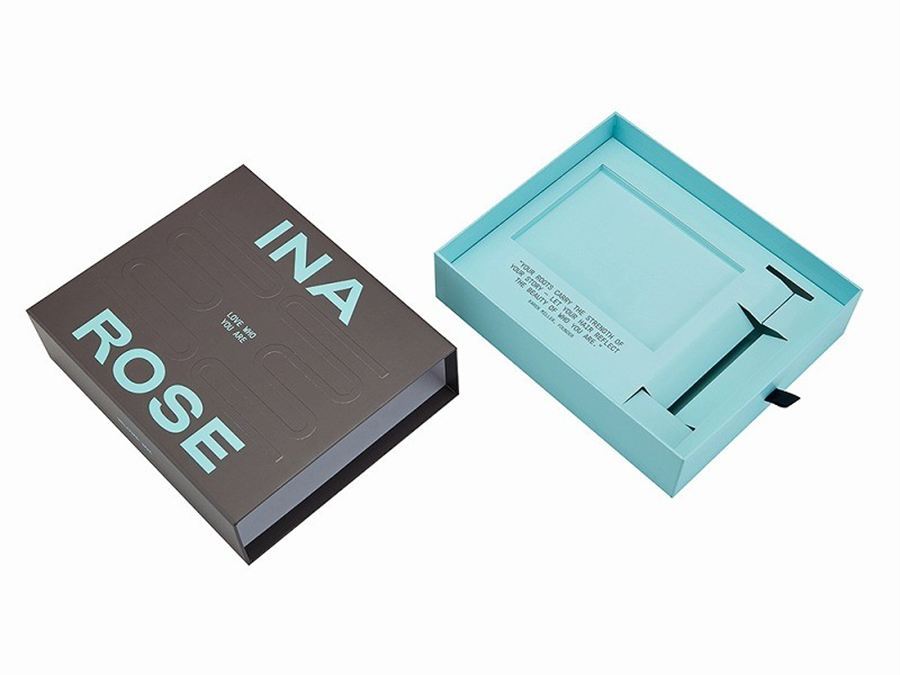 Custom printed rigid drawer box for skincare products on a packing bench