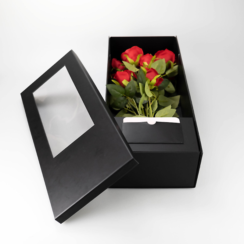 Open black flower gift box with clear PVC window lid and red rose bouquet