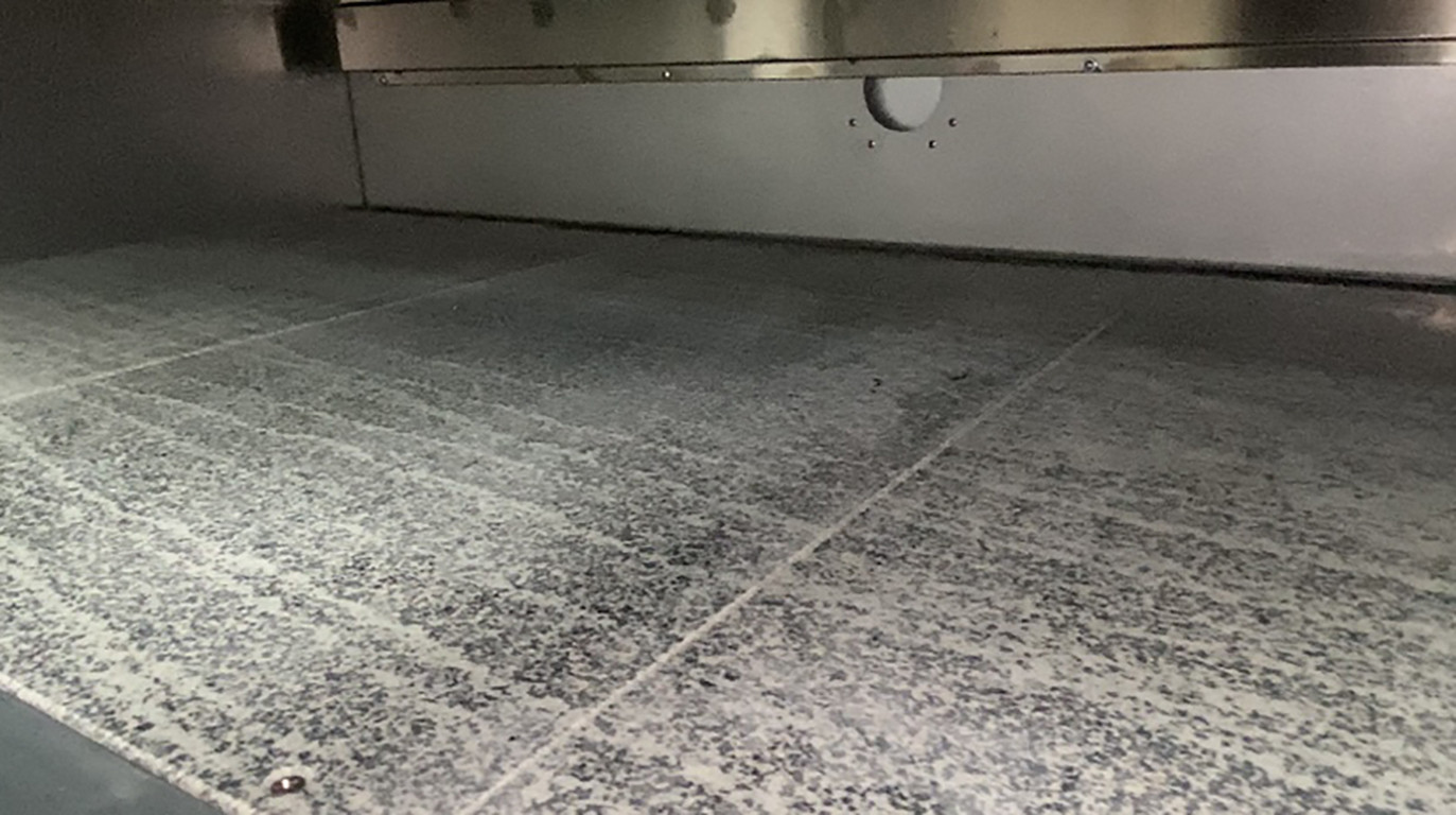 The oven chamber and baking stone of a commercial deck oven