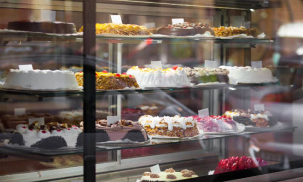 Stainless steel commercial deck oven for bakeries to bake bread, croissants, cakes, cookies, and other baked goods.