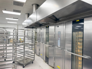 An eyebrow hood installed on top of a commercial deck oven, showing its position above the doors.