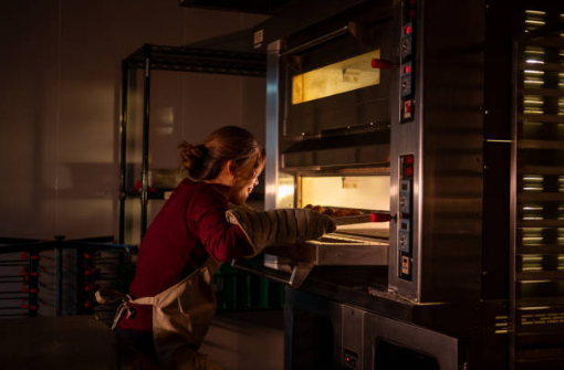 A modular deck oven being assembled, with one deck being stacked on top of another.