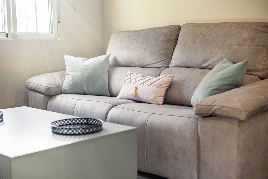 A family enjoying a chic, grey soft play sofa in a modern living room