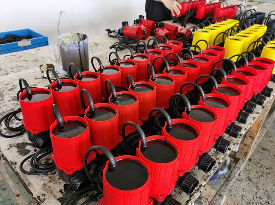 Pond pump manufacturing and quality inspection station showing submersible pond pumps, electronic controllers, and product samples for wholesale and OEM buyers