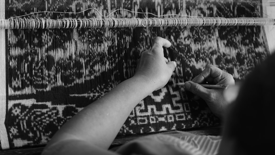 Artisan weaver working on a traditional loom for custom knitwear.