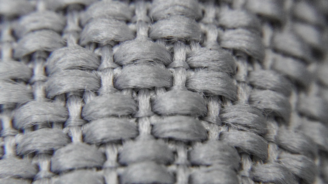 Close-up of intricate cable knit stitch on a merino wool sweater.