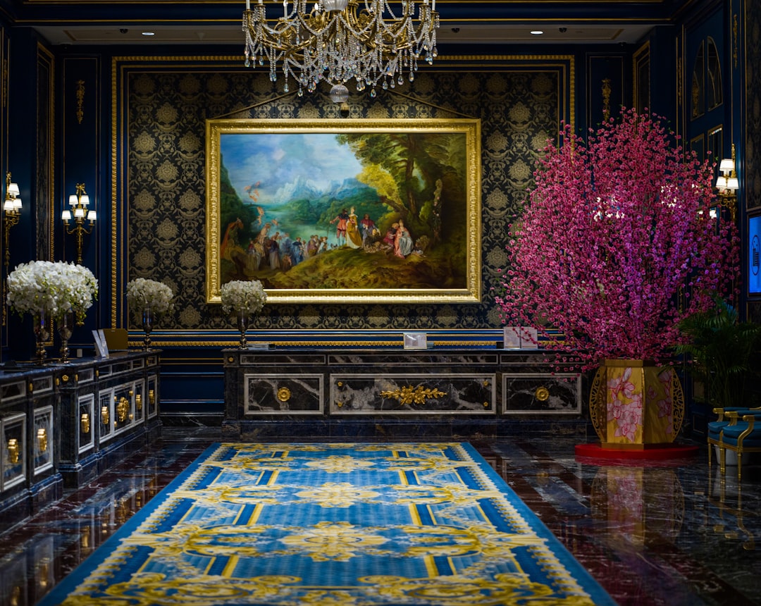 An elegant room with an Art Deco feel, featuring gold accents, geometric patterns, and a rich jewel-toned color palette.