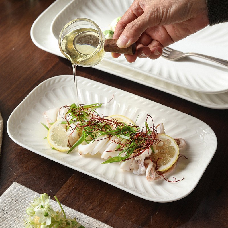 Textured White Ceramic Salad Plate with Fresh Green Salad on Dining Table