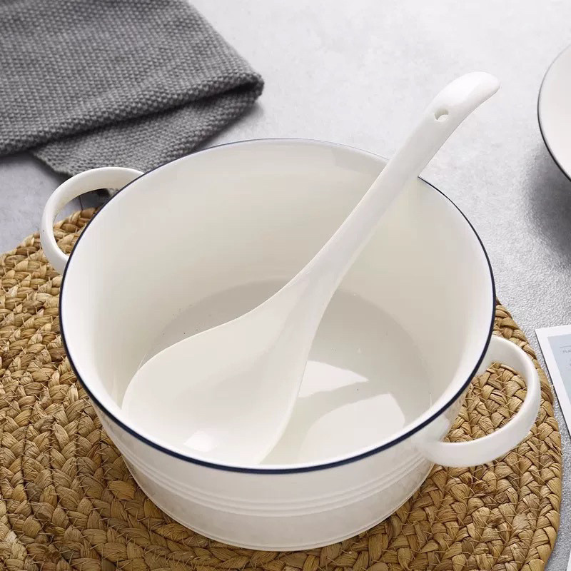 White Ceramic Spoon Placed In Kitchen Pot
