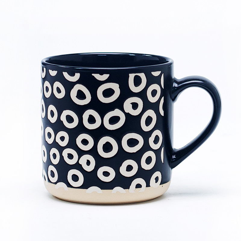 Black and white ceramic mug with swirl pattern front view