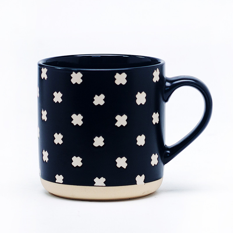 Black and white geometric mug with contrast spot patterns front view