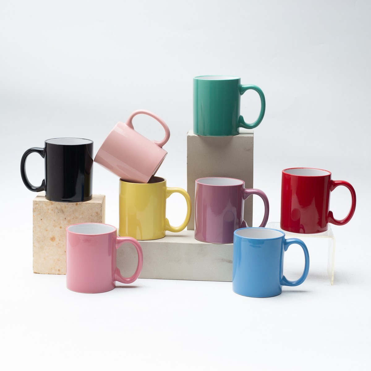 Seven glossy glaze stoneware mugs in assorted colors group shot