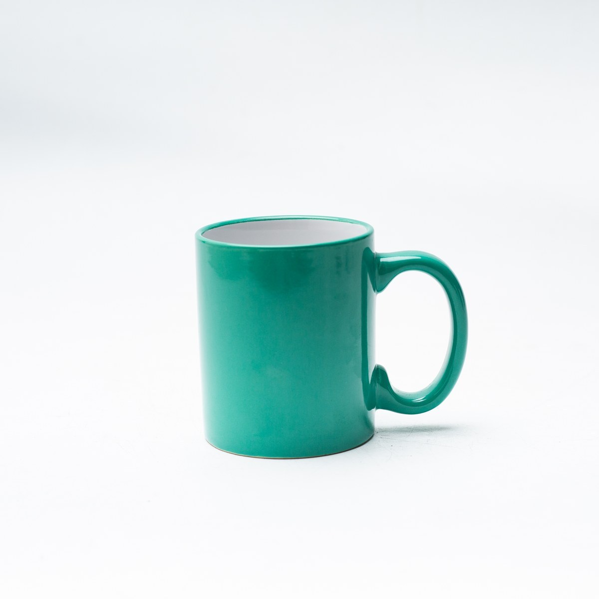 Teal glossy glaze stoneware mug cylinder body front view