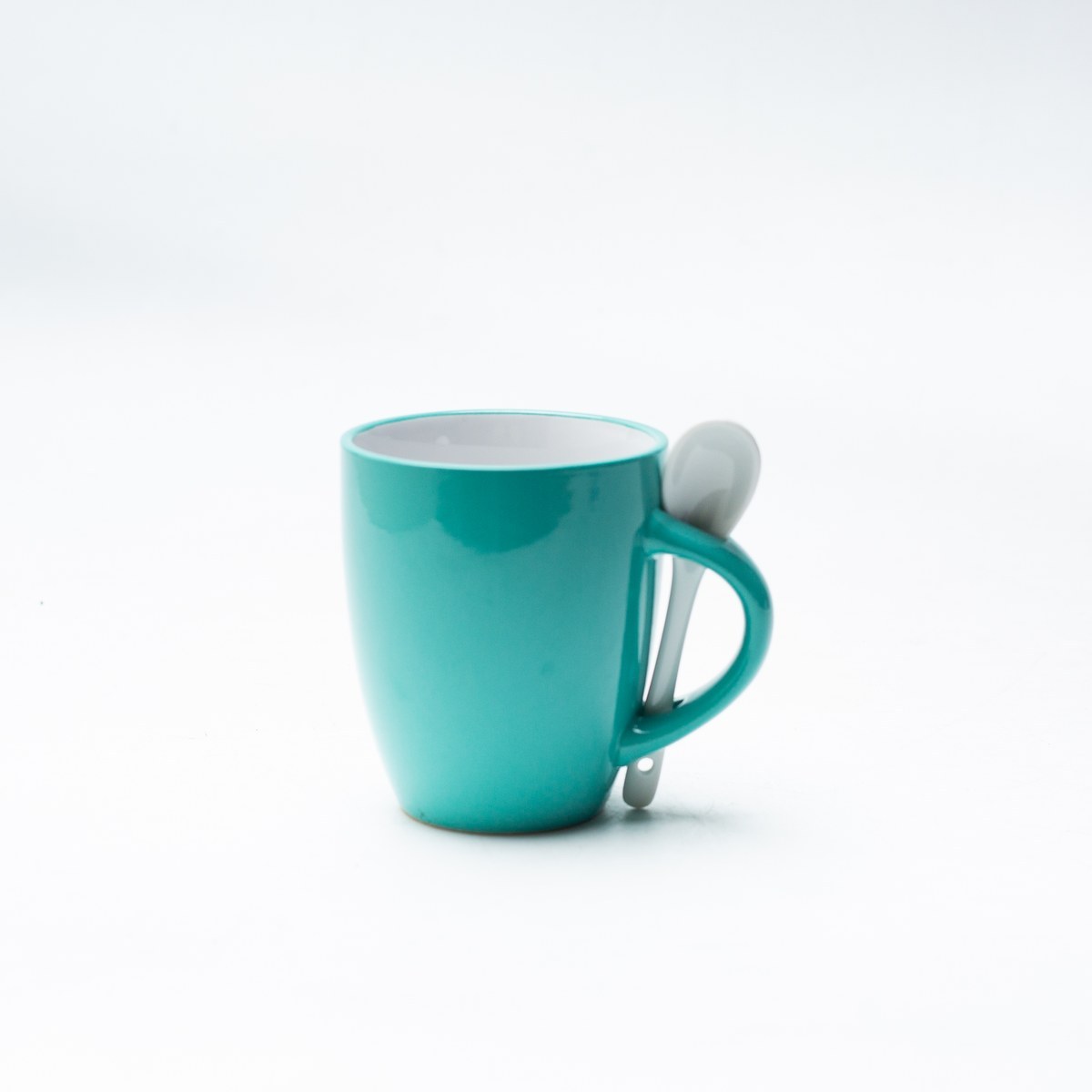 Teal spoon handle stoneware mug with spoon front view
