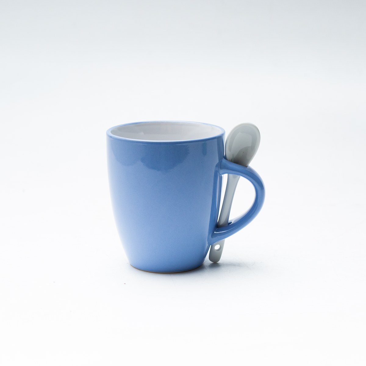 Light blue spoon handle stoneware mug with spoon front view