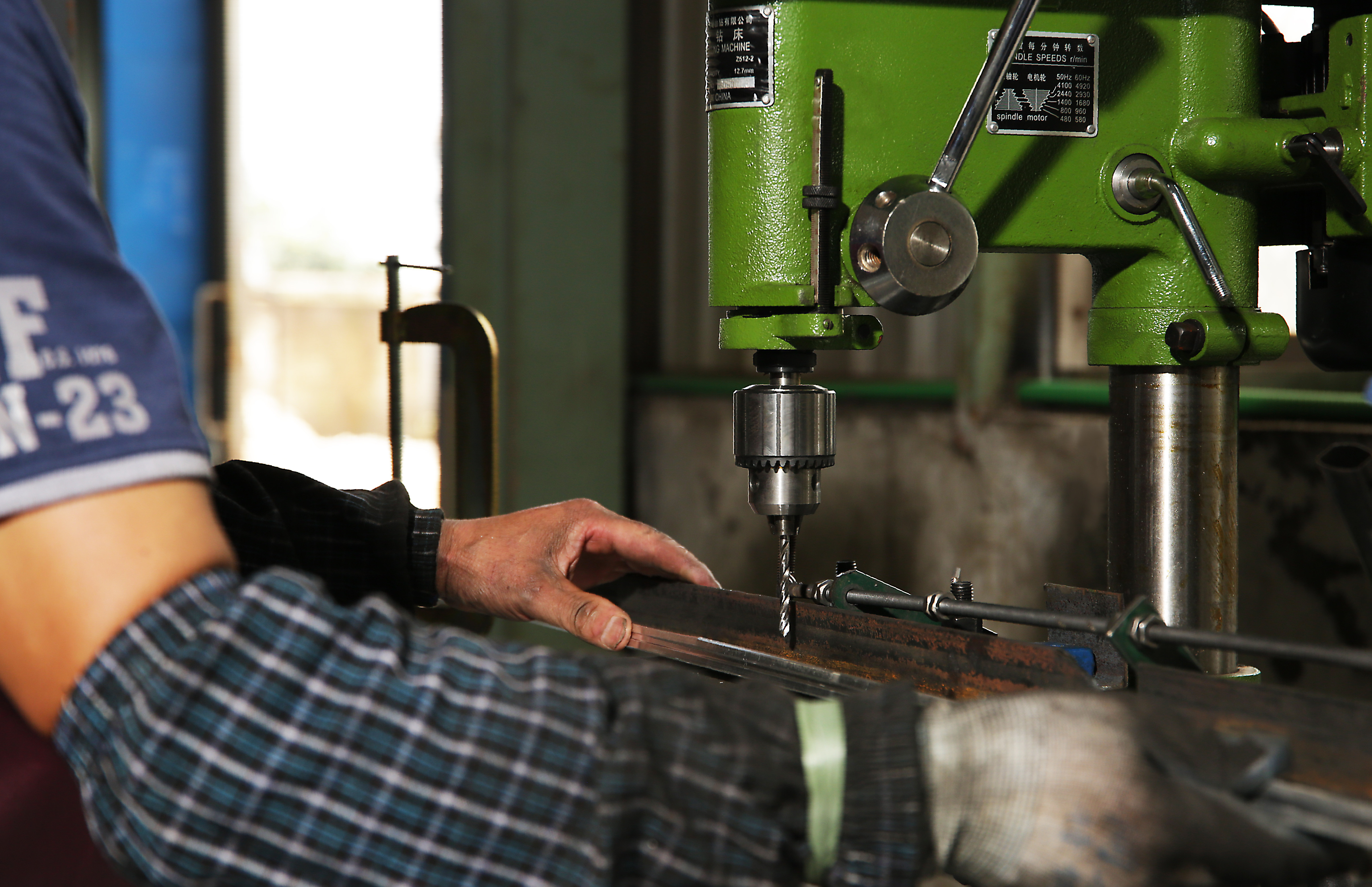 A factory assembly line for patio umbrellas, showcasing the OEM manufacturing process