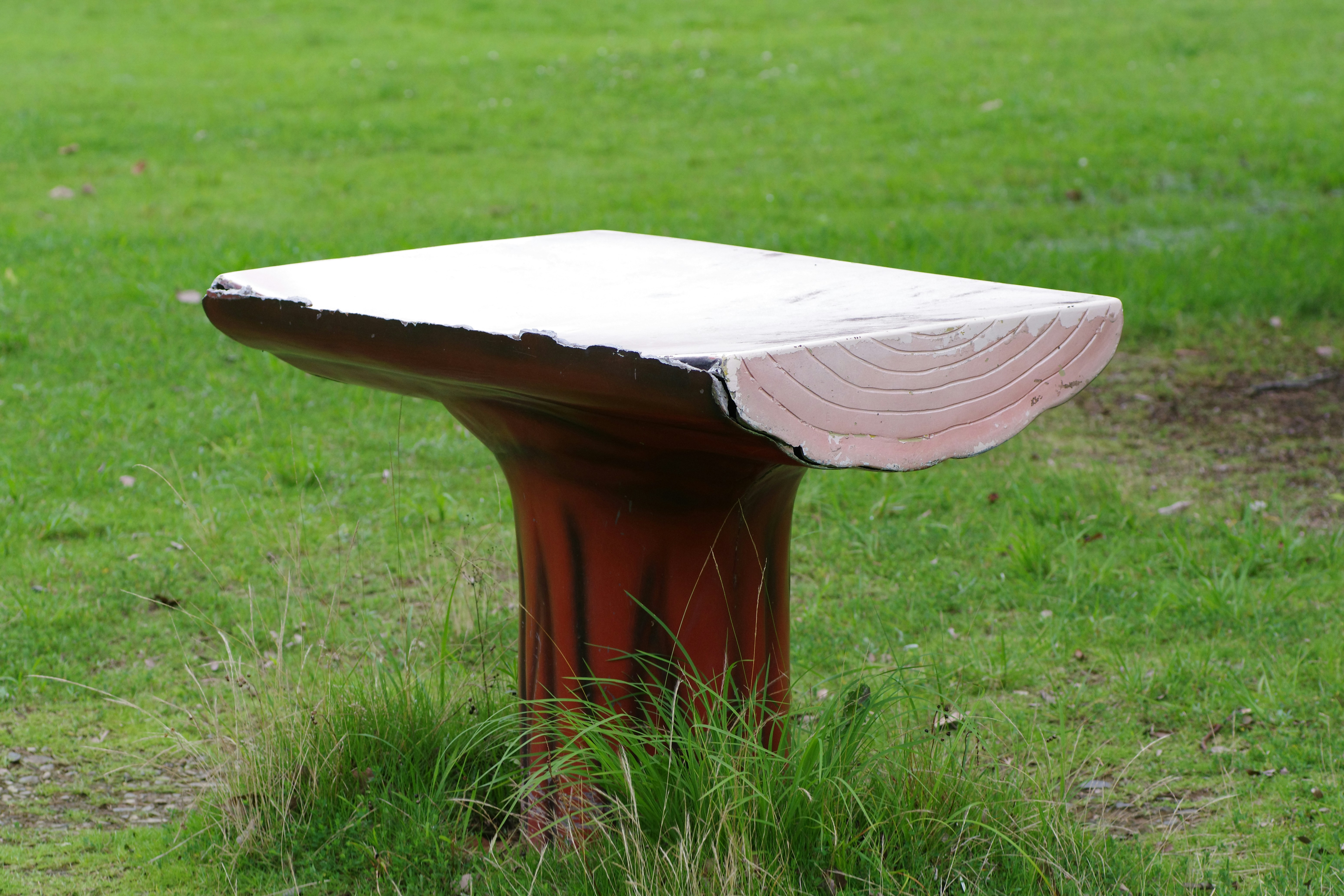 A classic wood-frame market umbrella shading a small bistro table