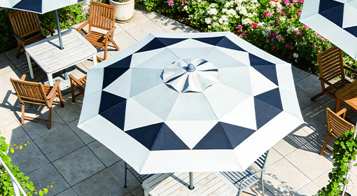 A beautiful, but high-maintenance, cedar wood pergola in a garden setting.