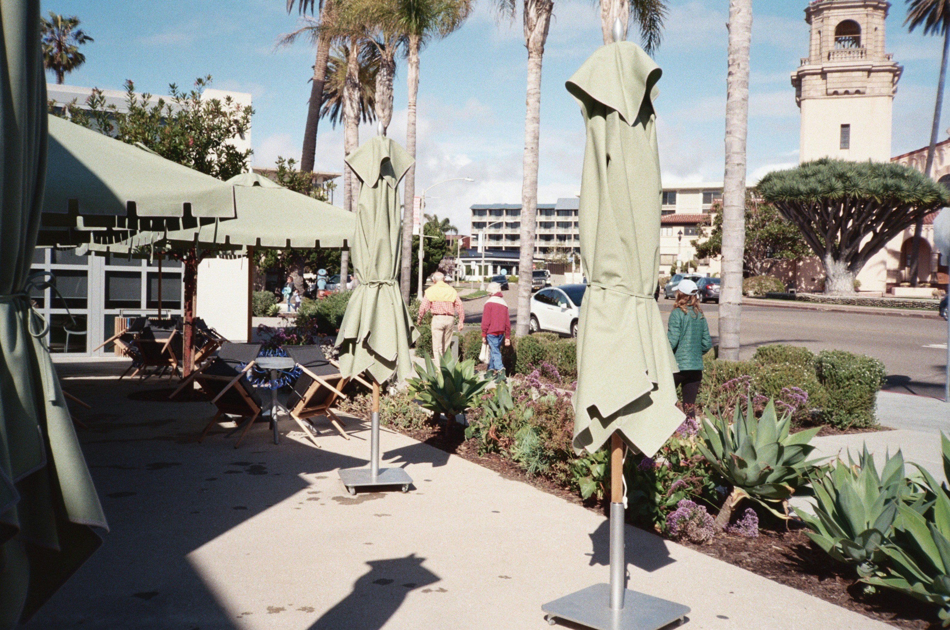 A faded and brittle patio umbrella with visible signs of weather damage.