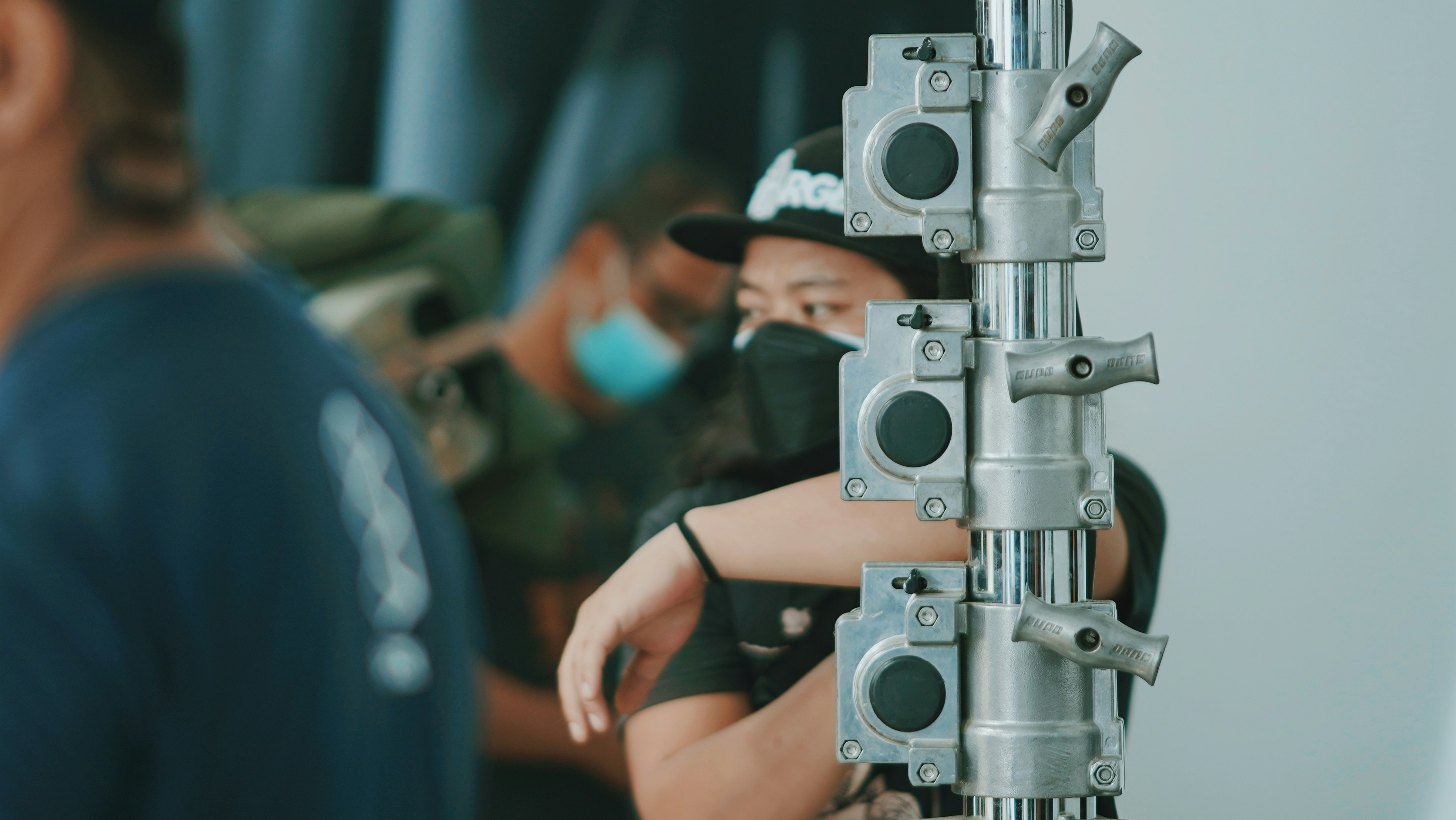 A person inspecting the mechanism of a center pole umbrella sample