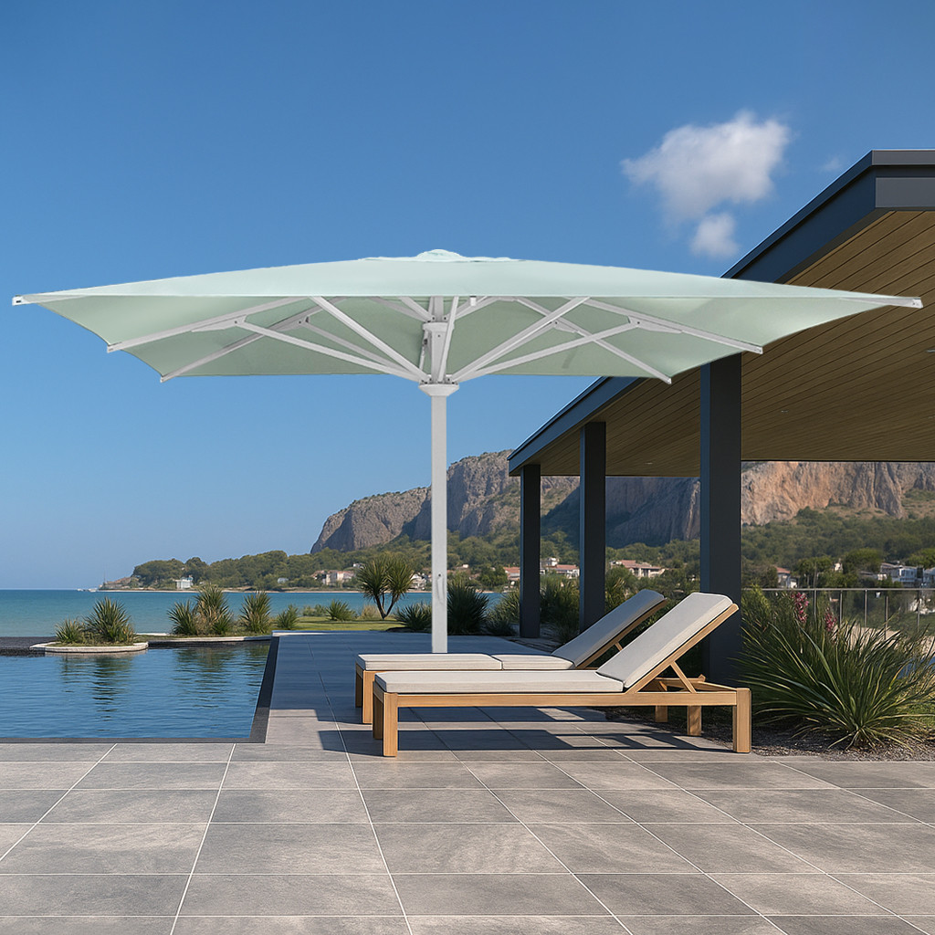 Large commercial pool umbrellas shading resort lounge chairs by the ocean