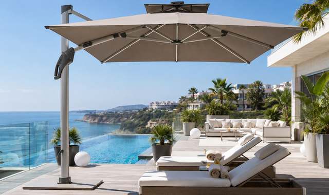 FHUM099 cantilever umbrella on a seaside pool deck with loungers