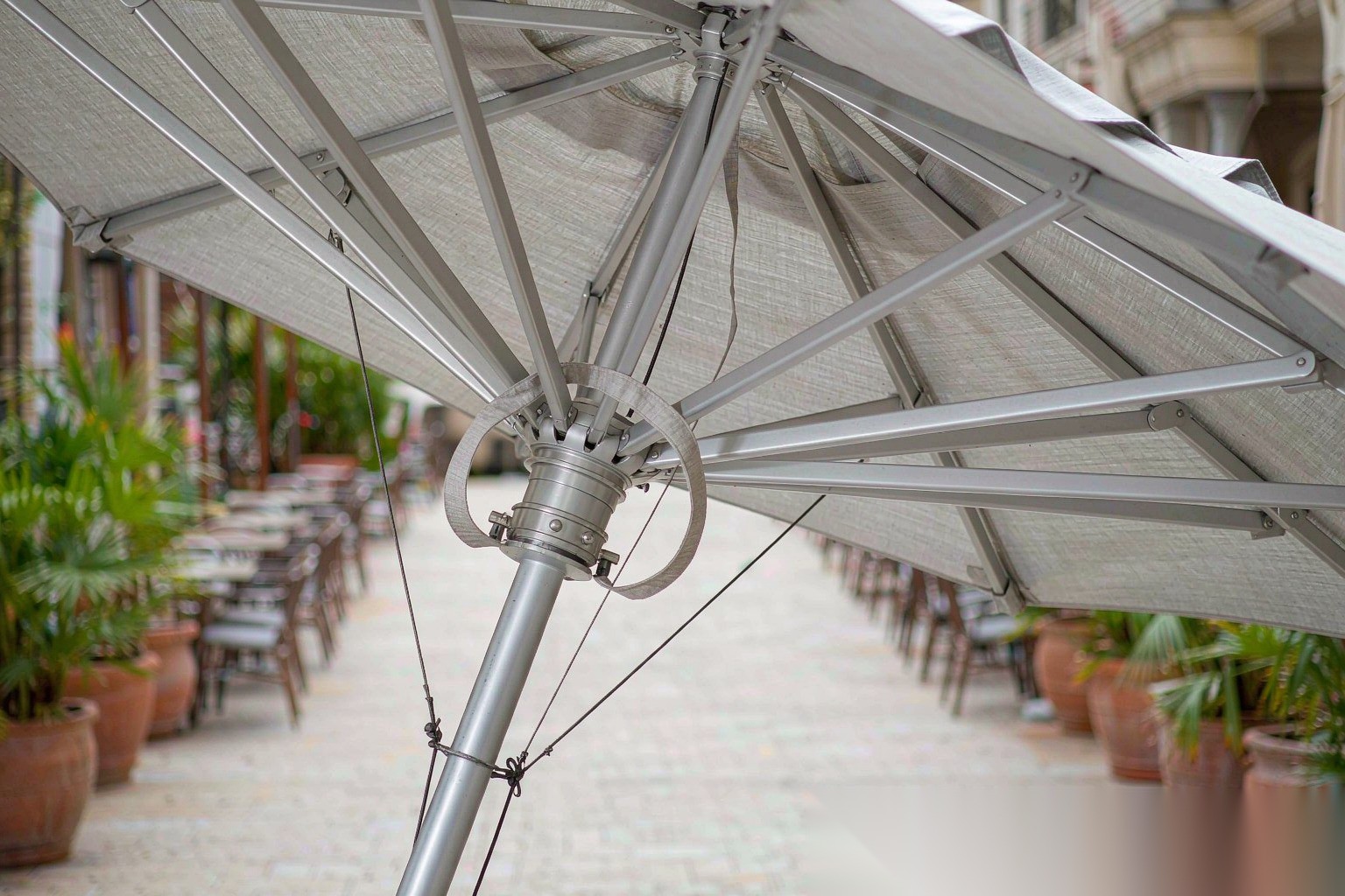 Close-up of reinforced aluminum ribs and hub on a restaurant terrace