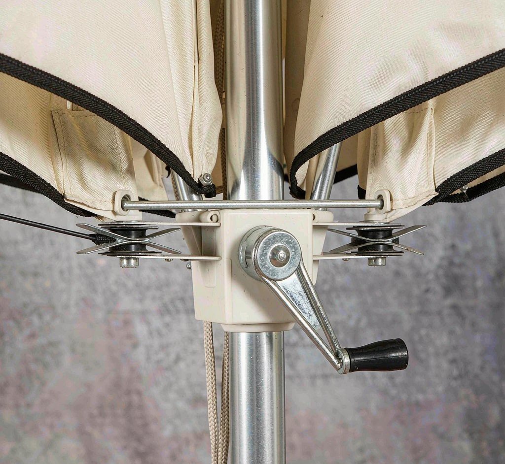 Close-up of an umbrella opening mechanism with pulley and crank