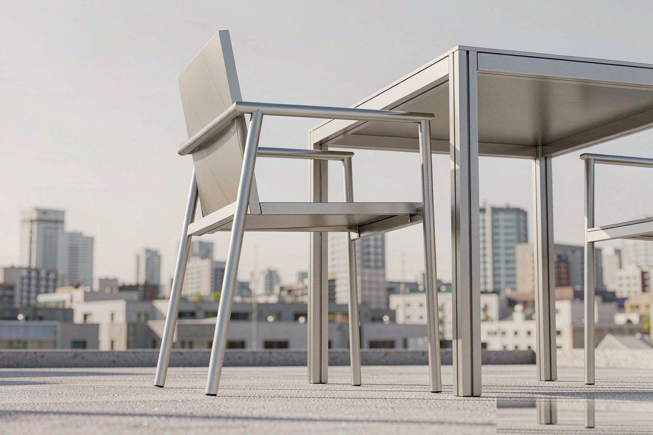 Slim aluminium-frame outdoor furniture on a minimalist rooftop terrace with city skyline