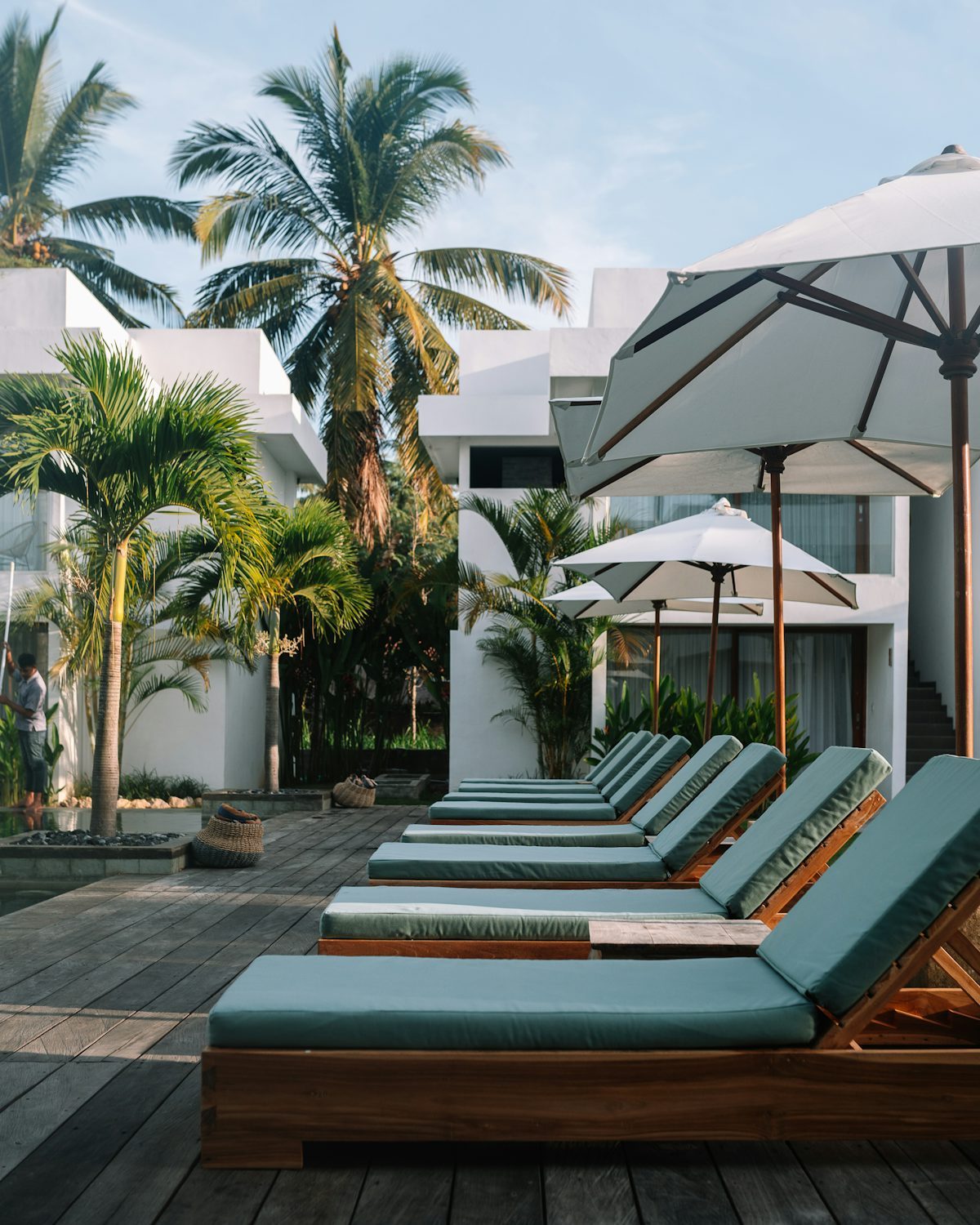 Lounge chairs and umbrellas on a timber deck in an exposed coastal setting