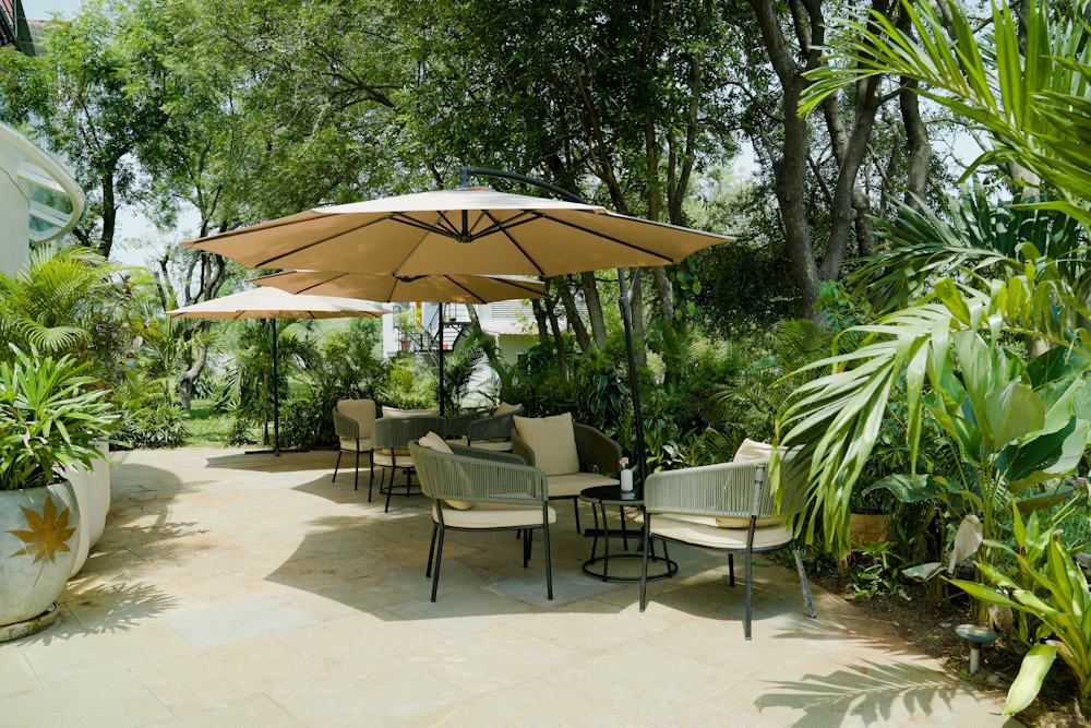 Designed garden lounge with large offset umbrellas over seating