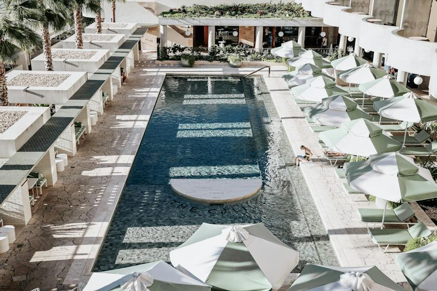 A designed pool terrace with rows of umbrellas repeating across the deck