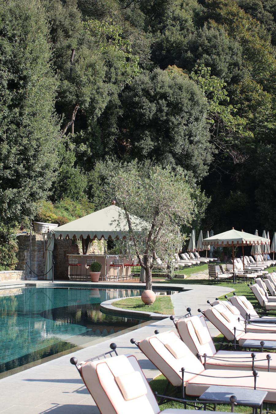 Resort pool terrace with parasols and a poolside pavilion