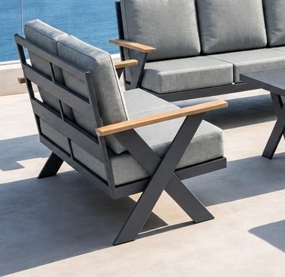 Wide solid teak armrest and crossed leg of the FHSF113 outdoor sofa set