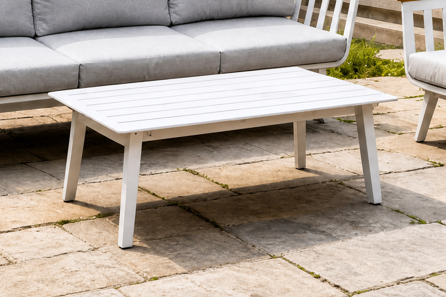 FHSF114 slatted coffee table with the sofa and single-seater on a stone patio