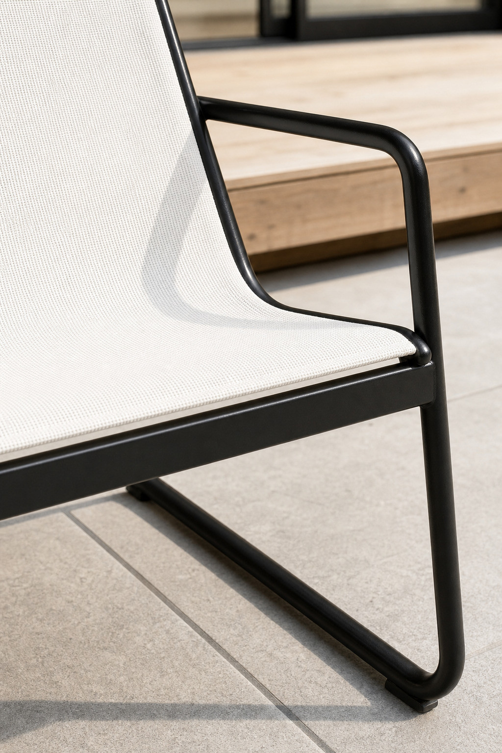 Close-up of the tensioned textilene sling meeting the slim black steel tube frame of the FHSF201 set