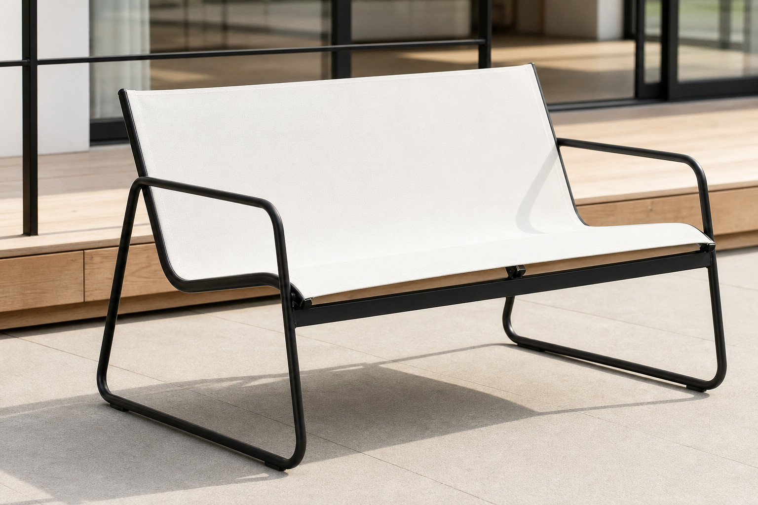 FHSF201 double-seater with its slim steel tube frame and textilene sling beside the black glass top table