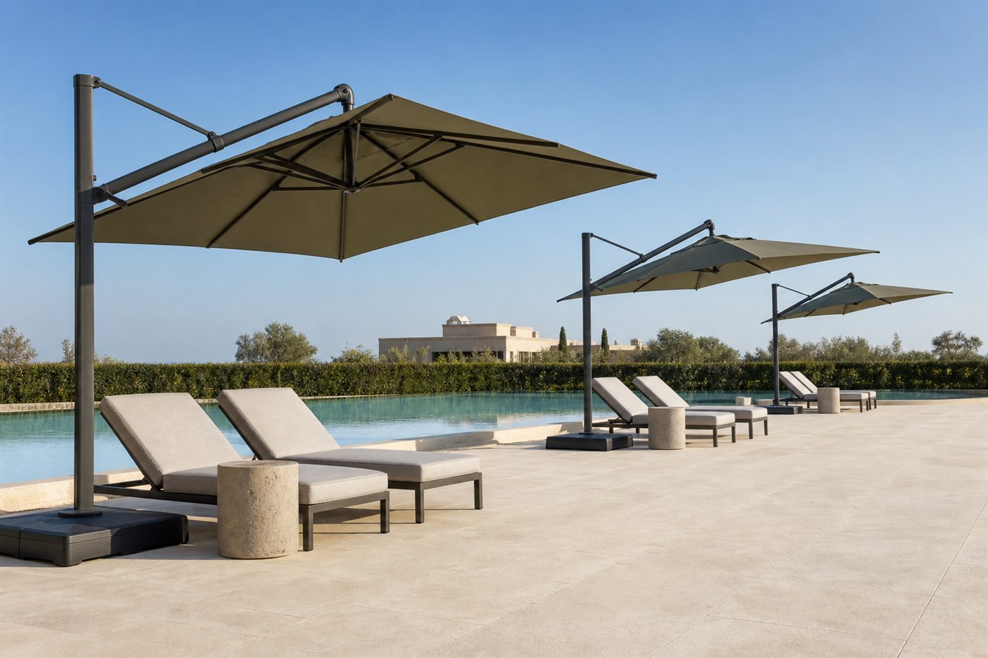 Row of cantilever umbrellas angled over loungers on a resort pool deck in daylight
