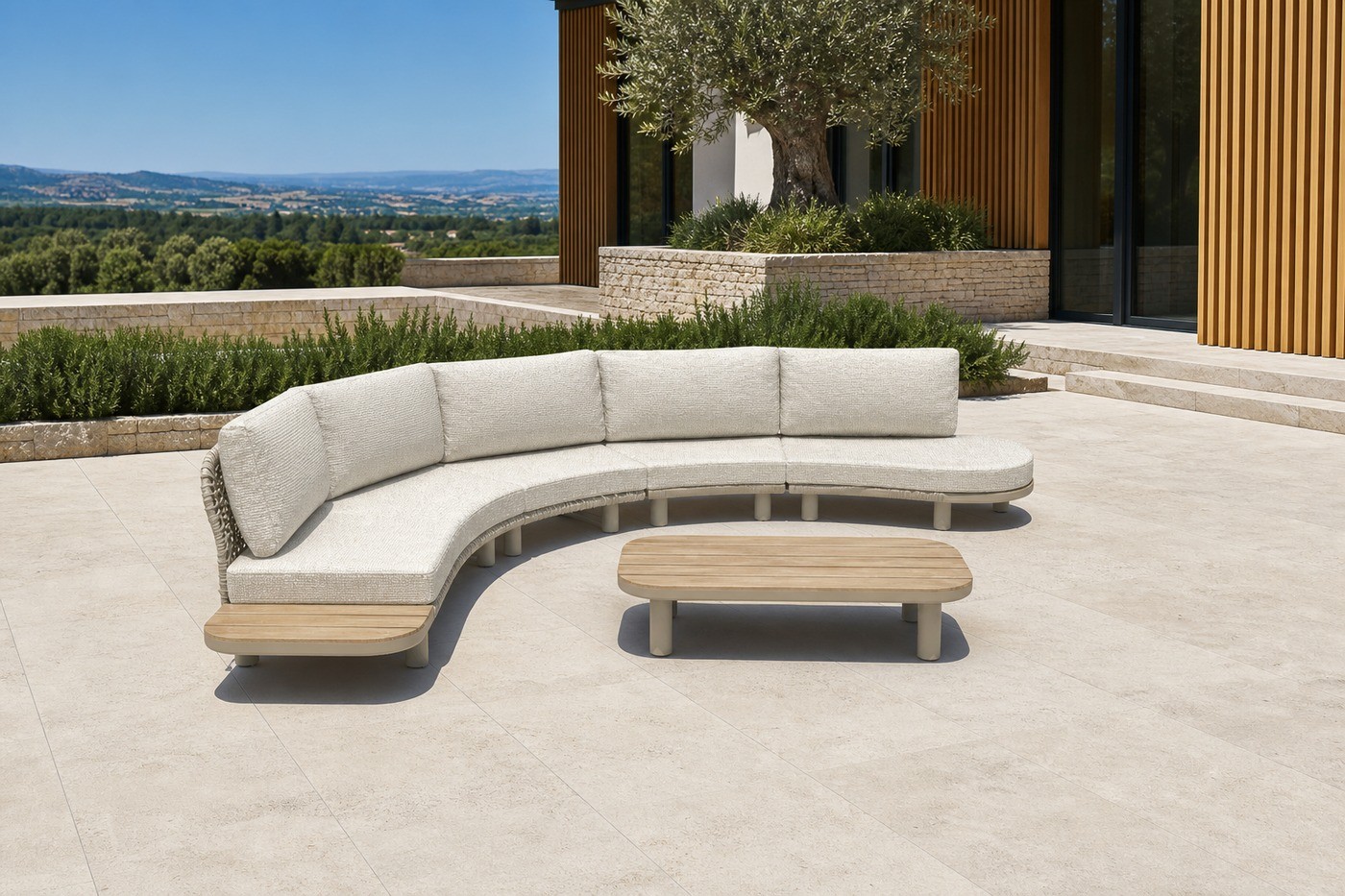 Curved modular sofa set on a villa terrace of pale limestone with an olive tree planter