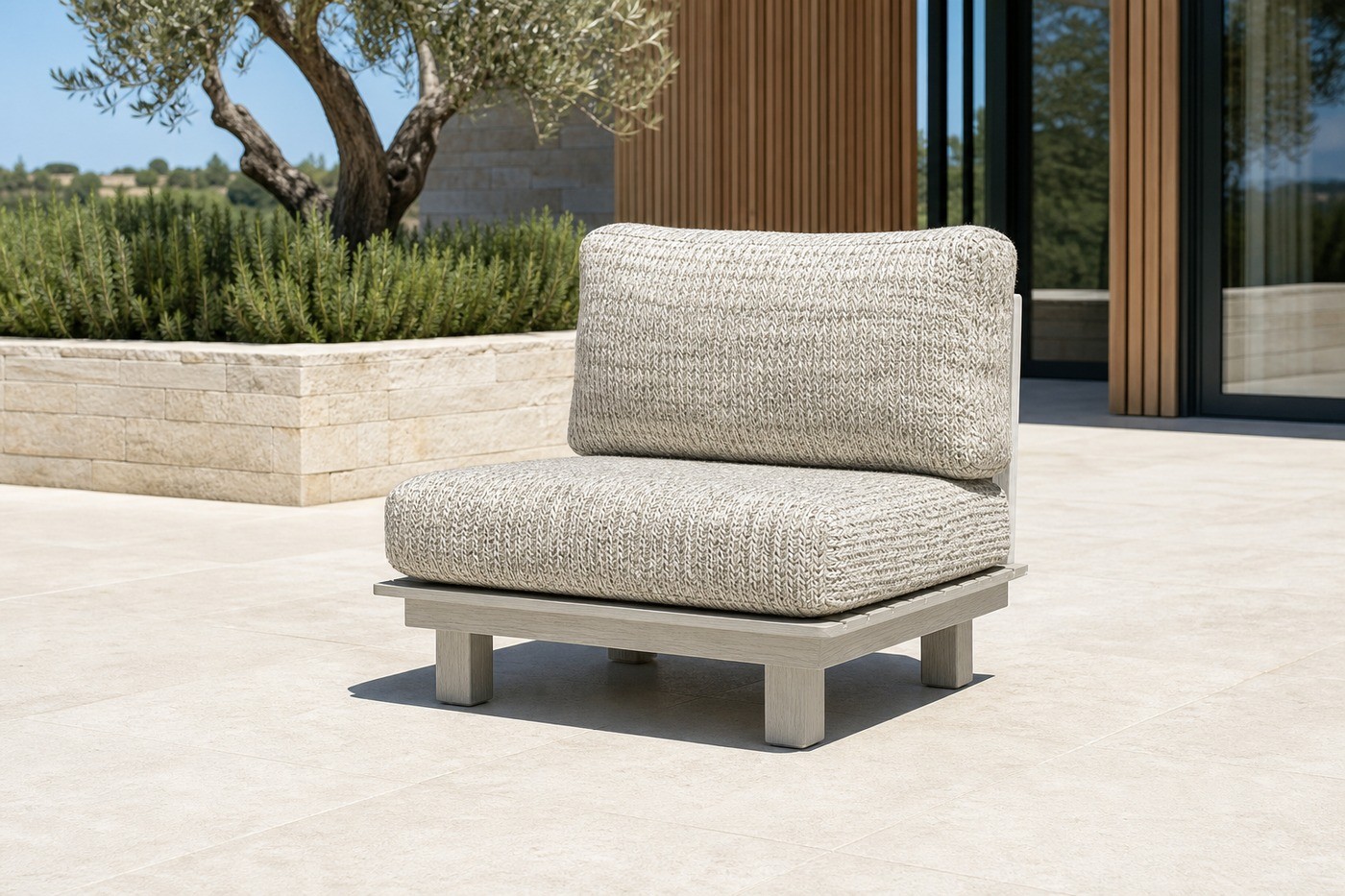 Curved outdoor sofa set facing an infinity pool with hills beyond