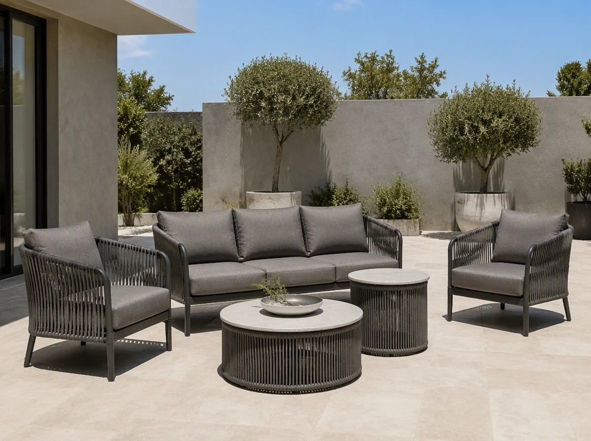 Rope weave outdoor sofa set with grey cushions and a charcoal frame on a modern villa terrace