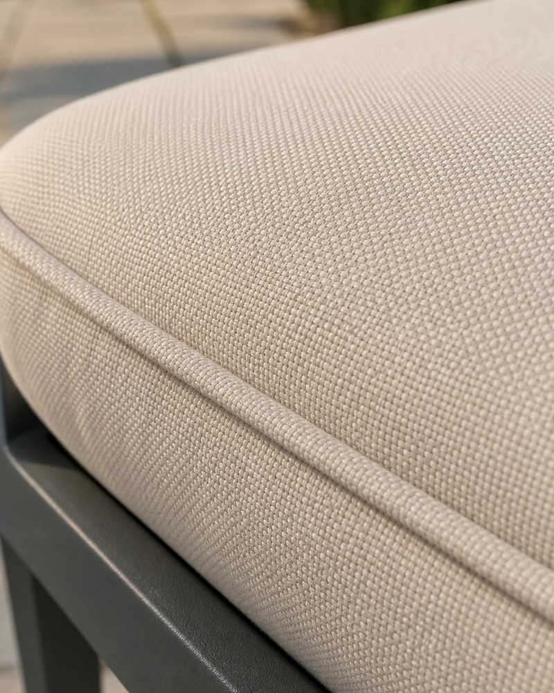 Cream polyester cushion fabric with piped edging on the outdoor sofa