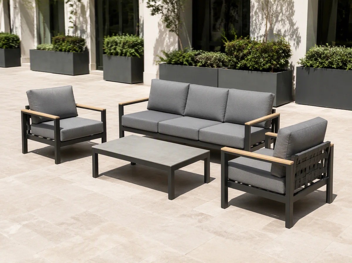 Charcoal aluminium outdoor sofa set with grey cushions on a wide hotel terrace of pale travertine