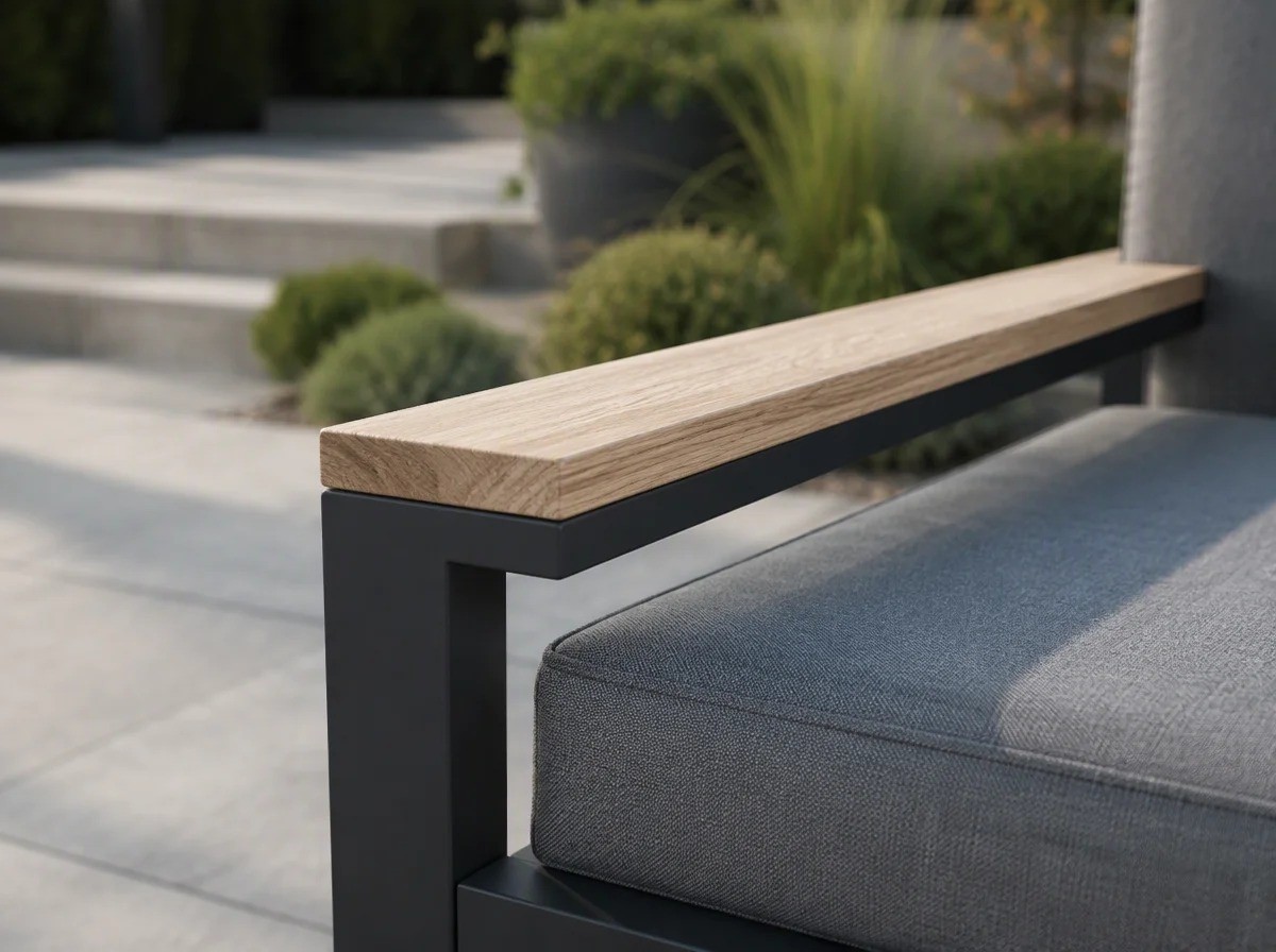 Close view of a light wood-look cap along the top of a matt charcoal aluminium armrest with a grey cushion below