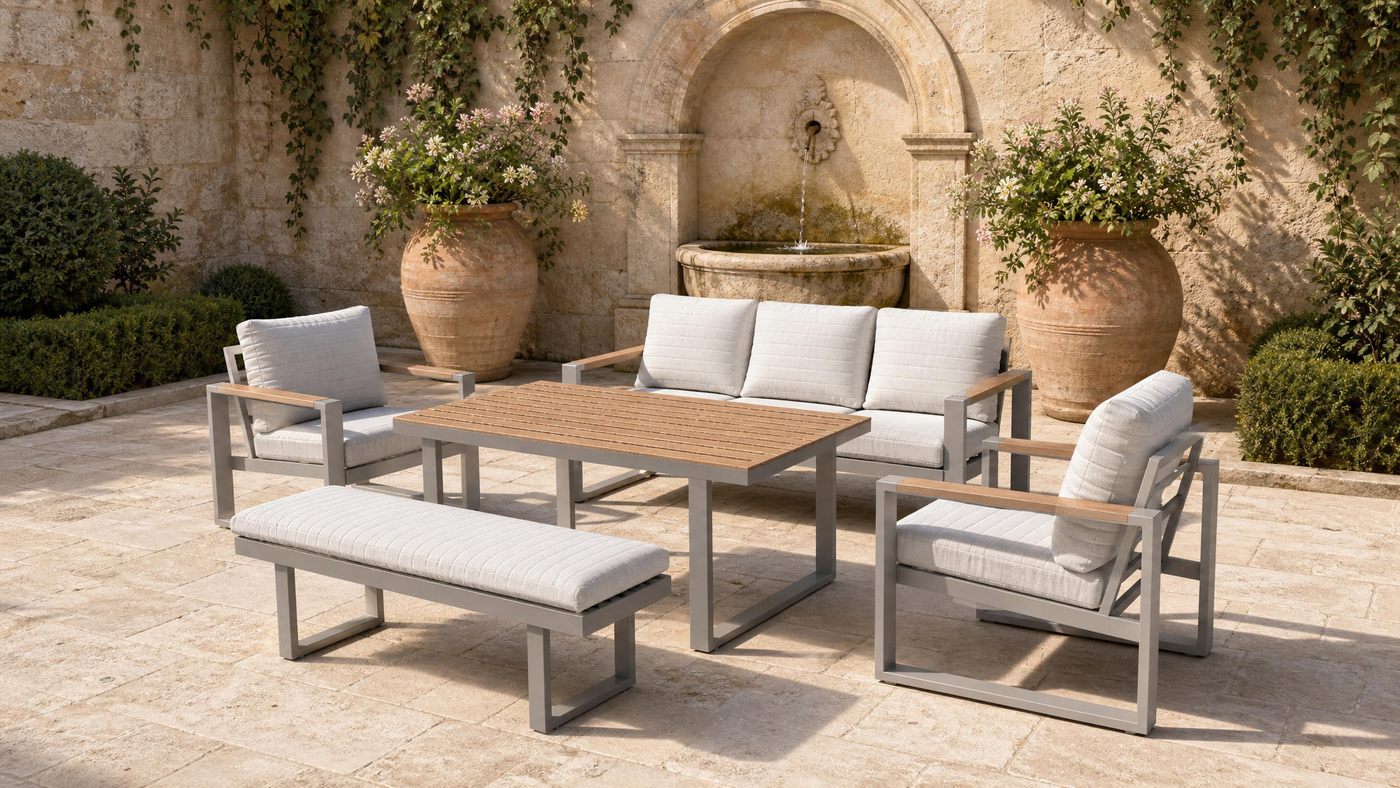 Aluminium outdoor sofa set on a stone courtyard terrace with a wall fountain