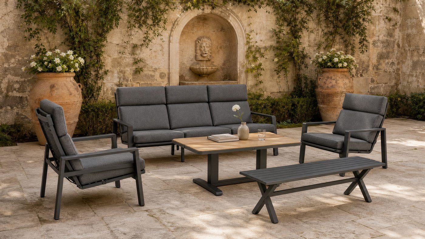 Aluminium lounge set on a stone courtyard with a wall fountain