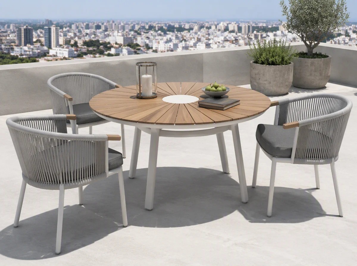 Round sunburst-slat outdoor table with three rope-back chairs on a designer rooftop terrace with a city skyline