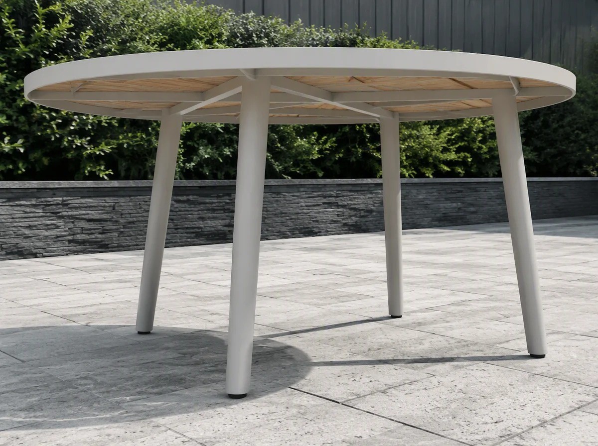 Close view of the base and legs of a round outdoor table with open space beneath the top